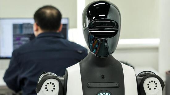 A robot appears next to a person at a testing site in Beijing, China. (Reuters)