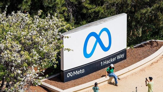 Visitors take photos at a sign outside Meta headquarters on Thursday, March 26, 2026, in Menlo Park, Calif. (AP Photo/Noah Berger) (AP)