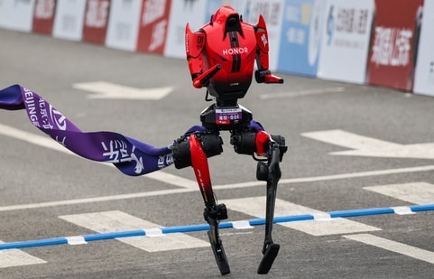 A Lightning humanoid robot by Honor crosses the finish line of the second Beijing E-Town Half Marathon and Humanoid Robot Half Marathon in Beijing (REUTERS)
